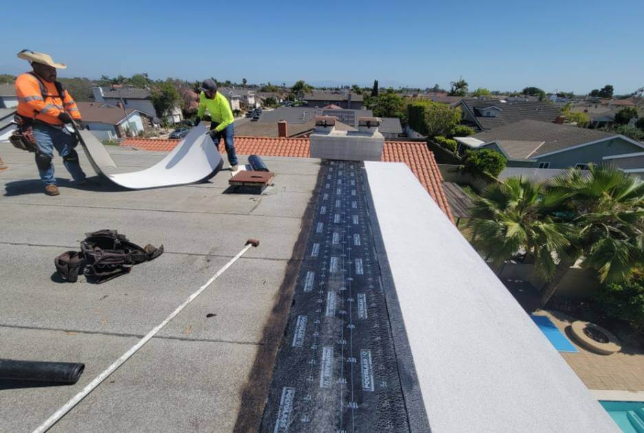 Men working on flat roof of a building