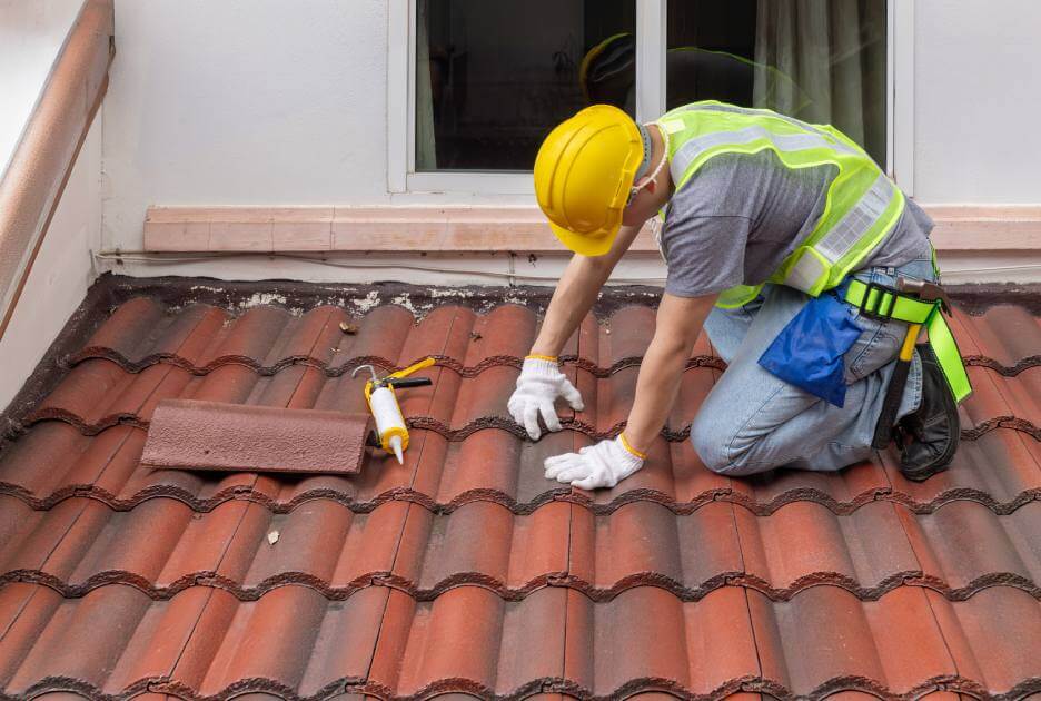 Man repairing clay shingles